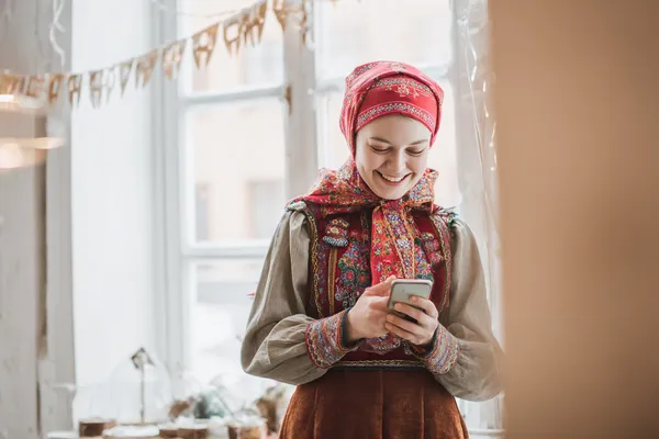 A woman in a luxurious green gown next to an ornate roulette wheel, capturing the upscale casino mood of JLJL10PH.