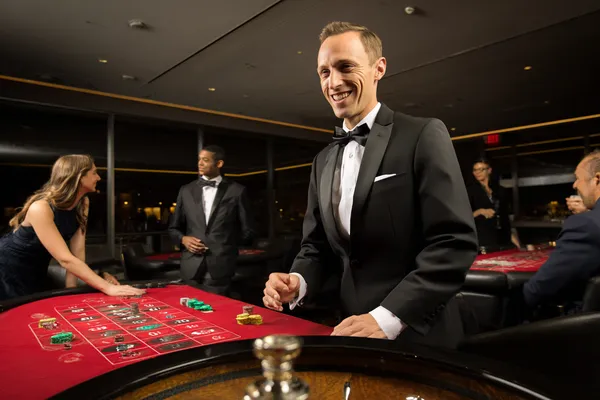 A woman smiling by bright slot machines showing lucky symbols, showcasing the exciting slot offerings at JLJL10PH.